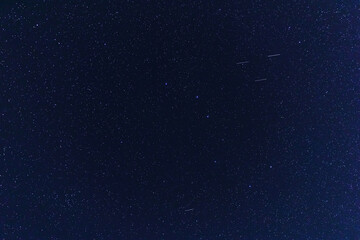 Fototapeta premium Constellations and Milky Way stars on a dark countryside skies.