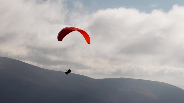 Paragliding active sport against giant mountains in highland
