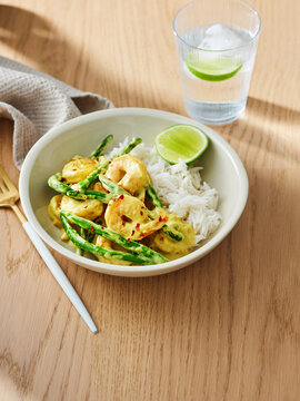 Shrimp curry with asparagus and jasmine rice, restaurant menu concept for flavorful dining experiences
