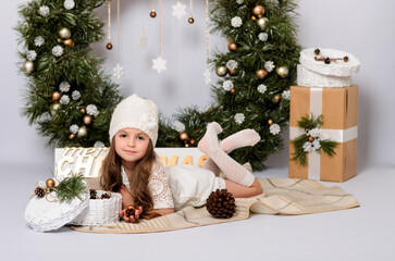 Obraz premium Christmas celebration. Cute little girl in a beautiful dress on Christmas. Happy New Year.