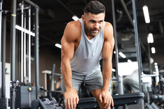 Sporty man resting, having break after doing exercise.