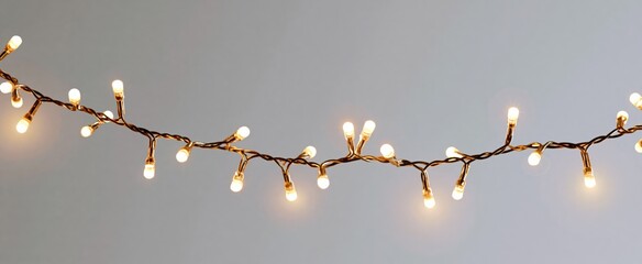 Obraz premium Elegant white Christmas garland lights twinkle like stars casting a cozy winter glow