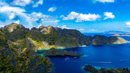 Obraz premium Aerial view of a beautiful tropical island with crystal clear water with limestone cliffs as the beach, Coron, Palawan, Philippines.