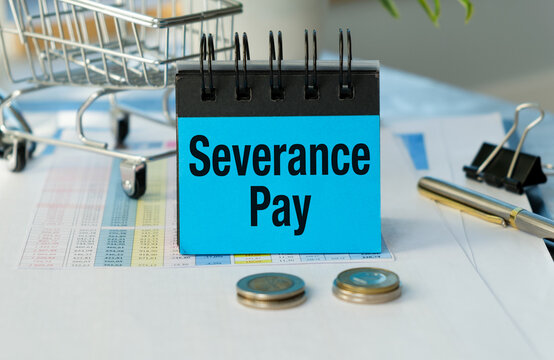Blue sign reads Severance Pay on desk. Coins rest nearby, hinting at financial release. Shopping cart suggests economic transition.