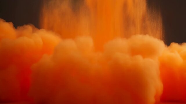 Vibrant orange smoke explosion creating a dramatic visual effect. Ideal for creative projects, advertising, and artistic expressions
