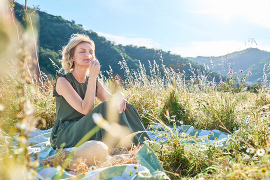Nature lover relaxing in a wildflower meadow on a spring day