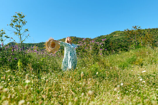 Nature enthusiast in a dress relaxing in a spring meadow