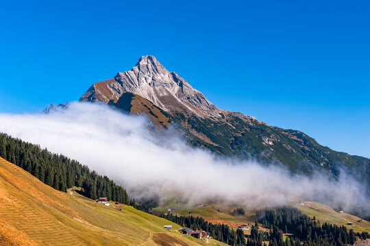 Low clouds below Biberkopf mountain peak in Lechtal Alps Austria