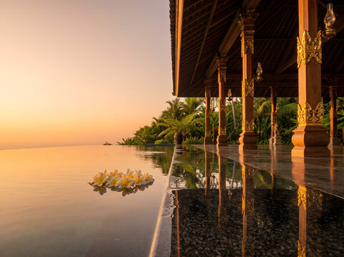 Thai Luxury Resort Pavilion Golden Hour with Granite Pool Surround and Frangipani Flowers