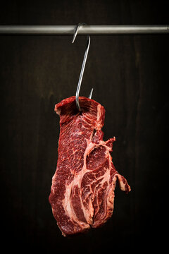 Raw american chuck eye steak on hook