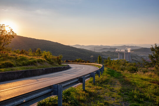 Italy, Tuscany, Country road in Val di Cecina at sunset