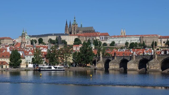 City of Prague at Vltava river in Czechia (Czech Republic). View to the Charles Bridge and Prague Castle on a hill, zoom in.