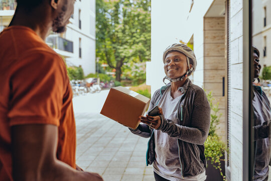 Smiling woman delivering package to customer