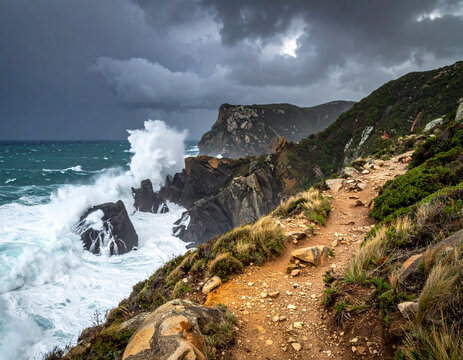 Rocky coastline with hiking path and crashing ocean waves