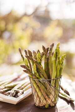 Fresh asparagus stacked in metal basket