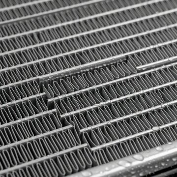 Close up view of a metallic radiator with intricate linear patterns