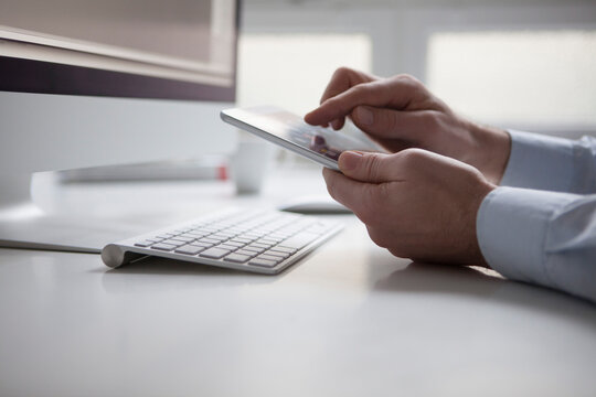 Man's hand typing on touchscreen of digital tablet