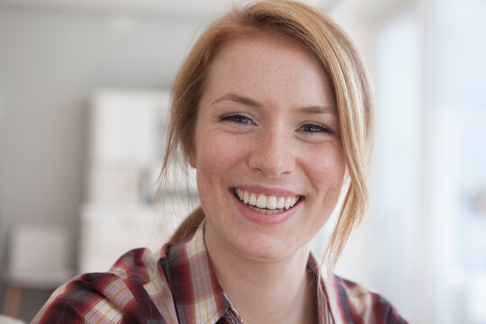 Portrait of happy young woman with freckles