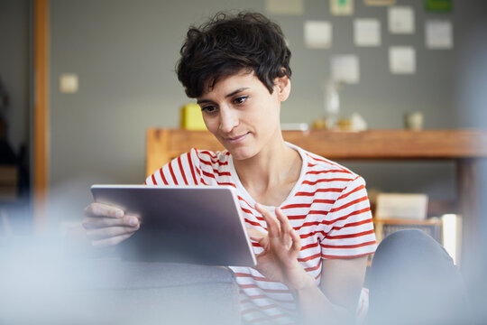Woman using tablet at home