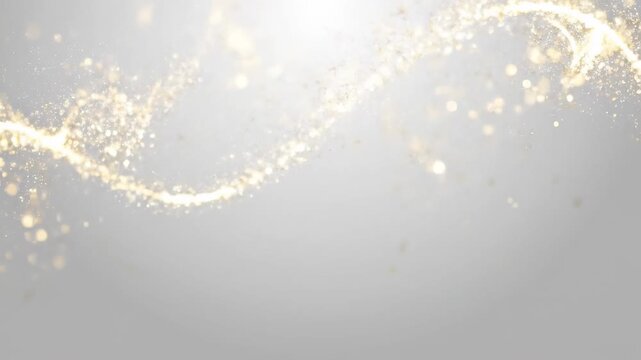 Golden particles wave in gentle motion against a soft grey gradient background creating a magical abstract concept