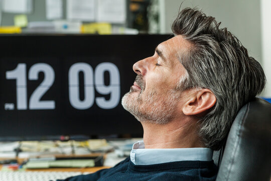 Mature man taking a nap at his office
