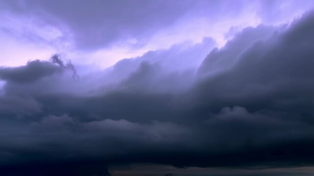 Dramatic storm clouds rolling in over a landscape at dusk. A powerful reminder of nature's beauty and unpredictability