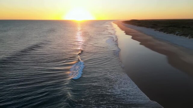 Serene sunset over a tranquil beach with gentle waves lapping at the shore. A perfect scene for relaxation and nature appreciation