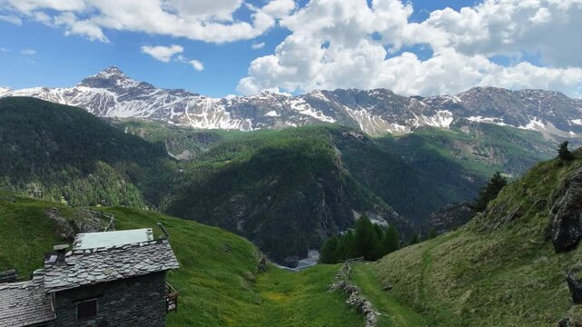 Dosso dei vetti, Chiesa in Valmalenco, Italy: drone view from the top of mountain in the middle of the valley