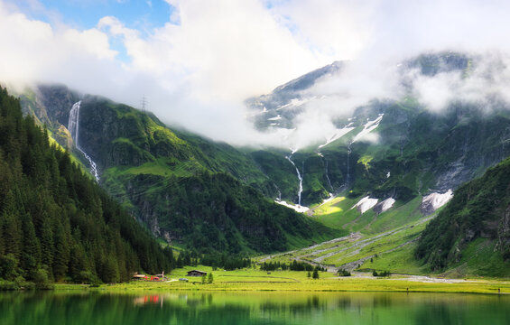 Amazing tourquise Hintersee with waterfalls and Austria Alps, Hohe Tauern landscape with mountain and lake