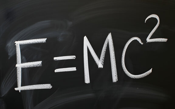A chalkboard with the famous equation E equals MC squared written in white chalk