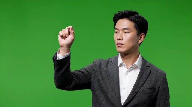 Businessman interacting with digital interface on green screen during presentation with subtle camera zoom