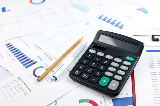 Calculator with pen and pencil on financial report chart. Concept of business data analysis, accounting audit, banking transaction, investment and budget planning.