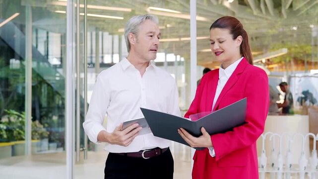 Office business meeting people man woman folder tablet discussion presentation in modern office with focused planning and professional teamwork