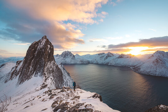 Snowy Segla peak on Senja, Norway, at winter sunset, with pink clouds