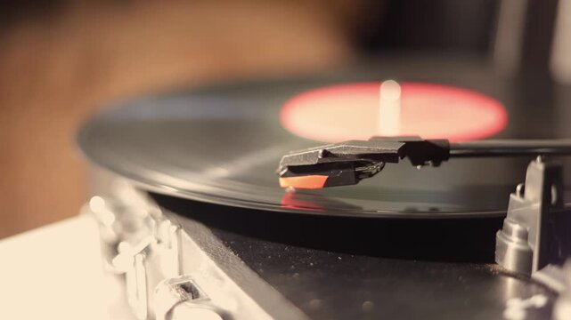 Close-up of a vinyl record spinning on a turntable with a stylus