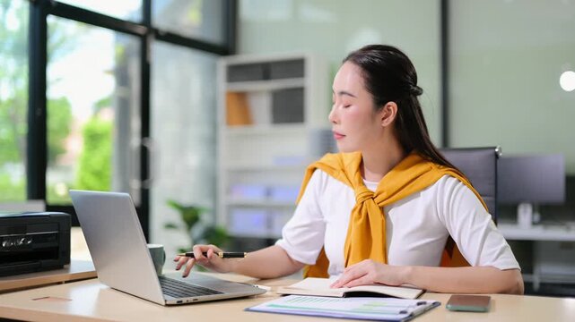 Business woman using tablet and laptop for doing math finance on an office desk, tax, report