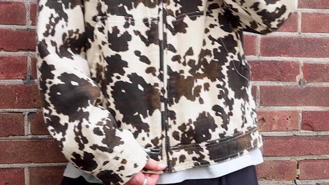 Video of a person zipping their jacket up.