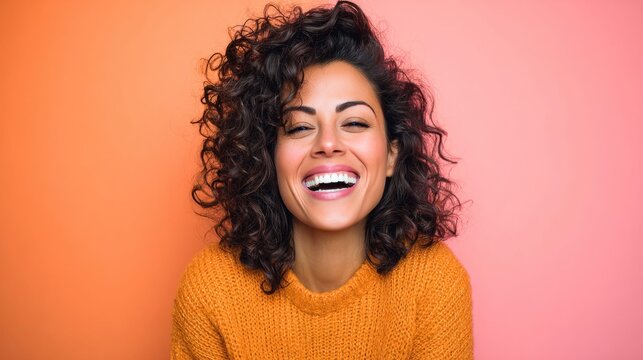 Happy woman with curly hair smiles broadly, radiating joy and positivity