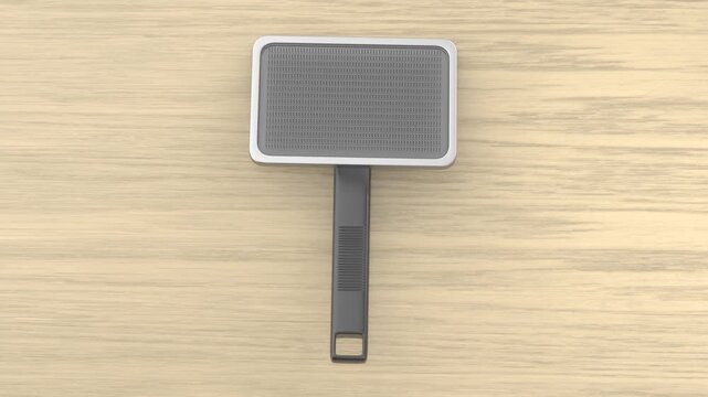 Pet grooming brush on wooden table