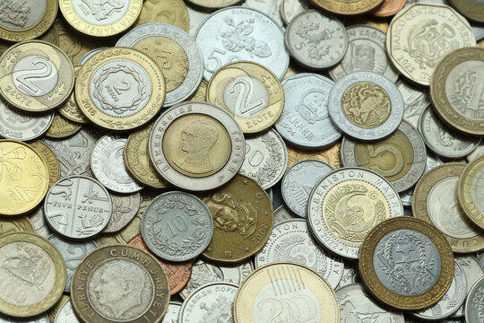 Big pile of coins from different money currencies. Treasure and numismatics concept