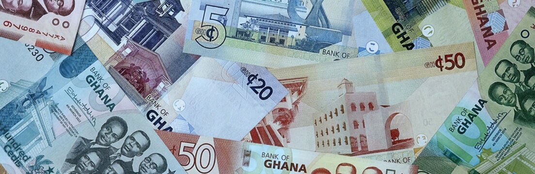 Ghanaian cedi money bills in pile. Big amount of Ghana GHS currency cash close up. Concept of casino