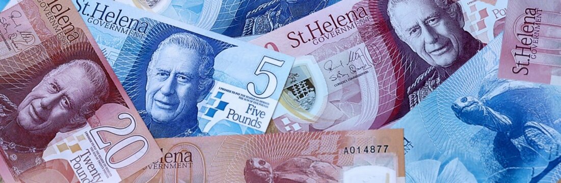 Saint Helena pound money bills in pile. Big amount of Saint Helena SHP currency cash close up