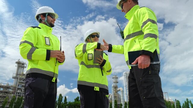 Construction team collaborating on project in industrial zone outdoor meeting teamwork in bright environment professional setting