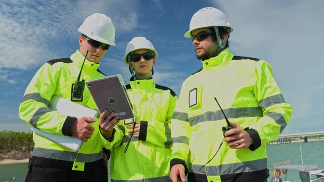 Safety inspections in the energy sector renewable energy facility team meeting outdoor wide angle collaboration