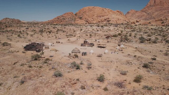 Aerial view of a himba village with huts and houses in the spitzkoppe desert, damaraland, namibia