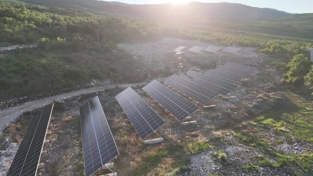 A beautiful aerial drone shot of a small-scale, community solar farm nestled within a rural landscape