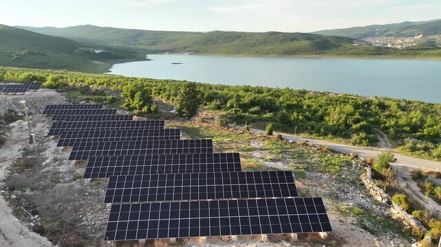 A beautiful aerial drone shot of a small-scale, localized solar farm situated within a rural landscape