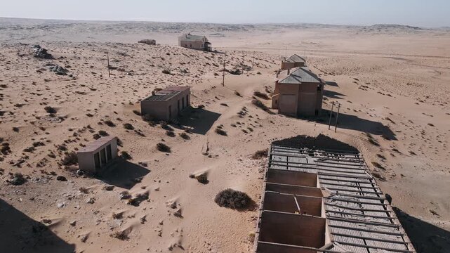 Abandoned ghost town kolmanskop in namib desert, namibia. Aerial view of decaying houses swallowed by sand and desolation