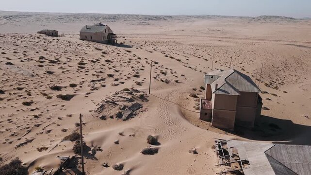Aerial view of the abandoned ghost town of kolmanskop in namibia. Derelict houses and buildings being swallowed by shifting sand dunes