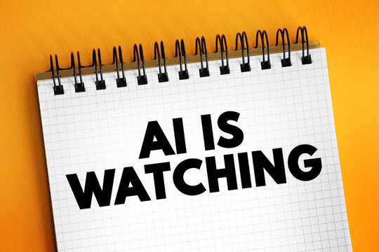 AI IS WATCHING text written on a piece of paper. This statement warns about the prevalence of pervasive monitoring technologies and data collection capabilities in the modern digital age.
